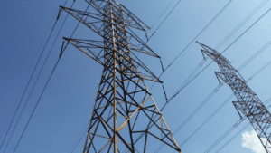 high voltage power lines in the sky against a blue sky