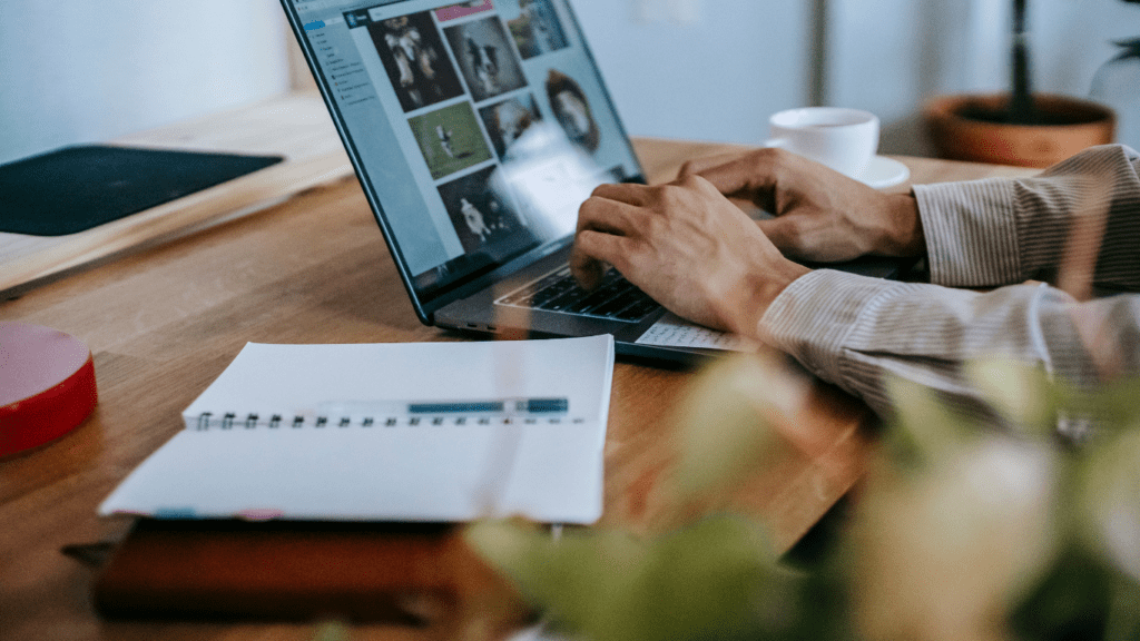 A person sitting at a desk with a laptop and books