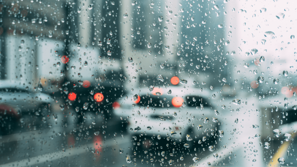 rainy city street with cars and traffic on a rainy day