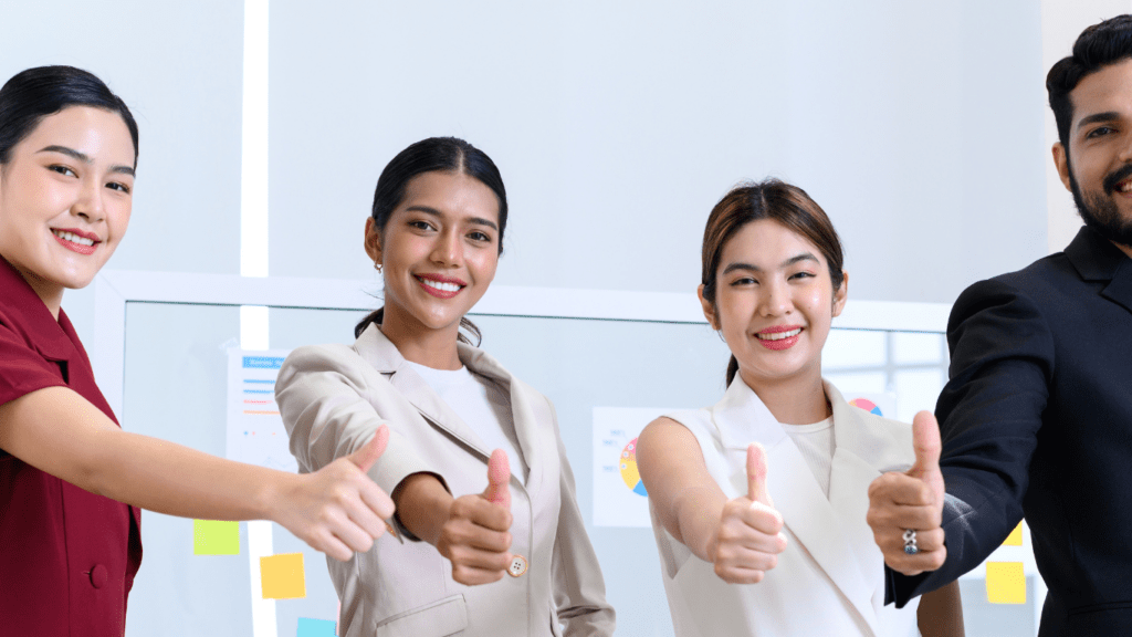 a group of people showing thumbs up in front of each other