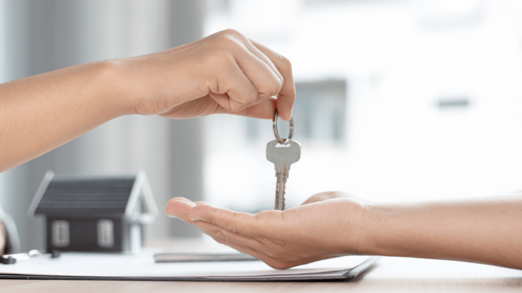 a person handing a key to another person