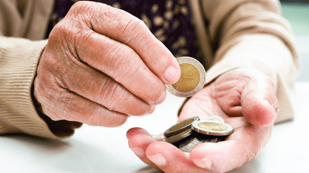 a person is counting money in front of a desk