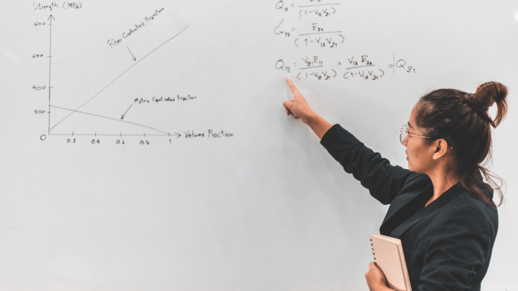 a person writing in a white board