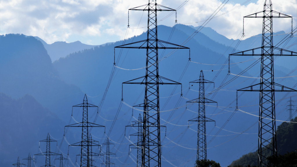 high voltage power lines in the sky against a blue sky